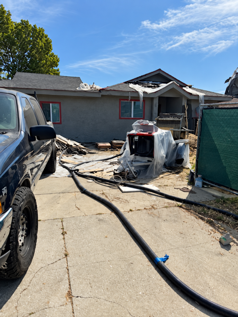 Stucco equipment and hoses at a residential project
